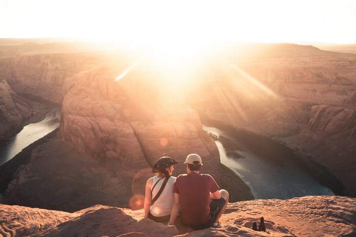 Couple watching sunset over Horseshoe Bend, Arizona