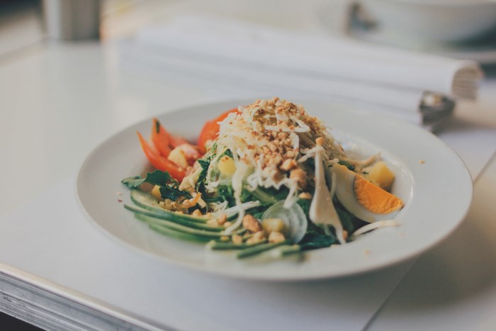 Salad with egg, cucumber, and peanuts on a plate