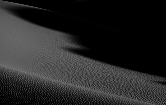 Black and white desert sand dunes at night