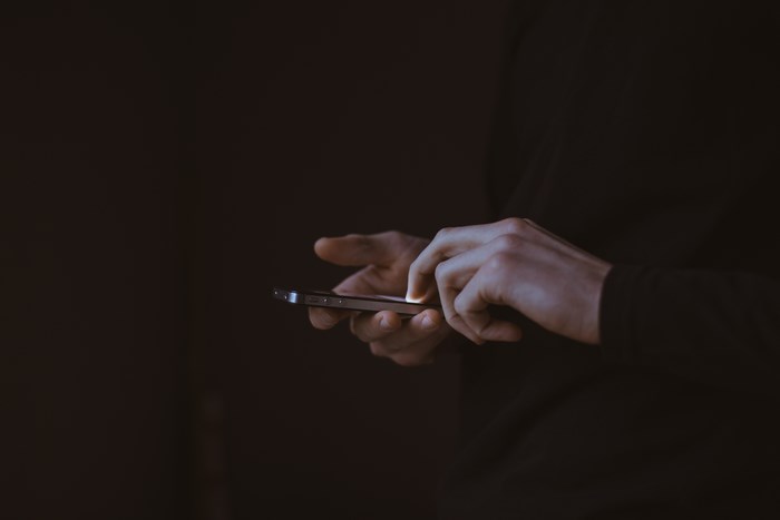 Person using a smartphone in the dark