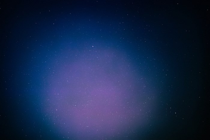 Night sky with stars and purple nebula over Tehran