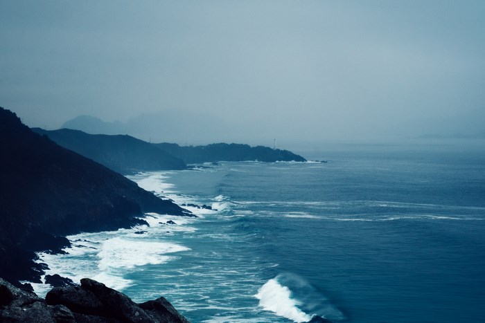 Misty Coastline with Crashing Waves