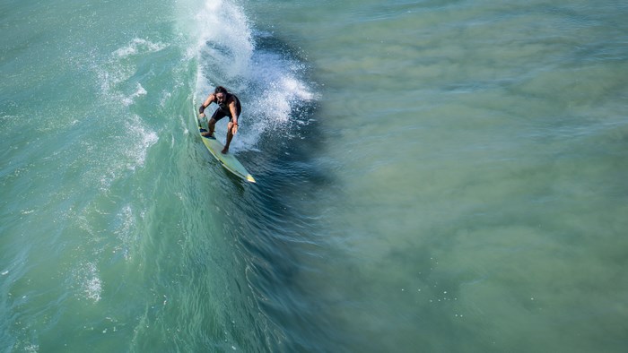 Surfer riding a wave in the ocean