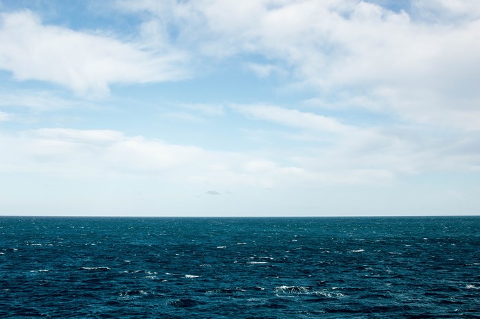 Blue ocean and sky with clouds