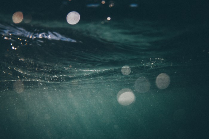 Underwater view of ocean waves with light reflections
