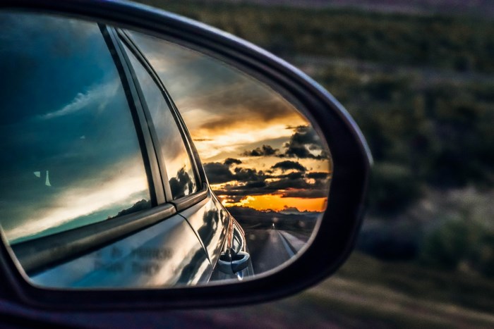 Sunset reflected in a car's rear view mirror