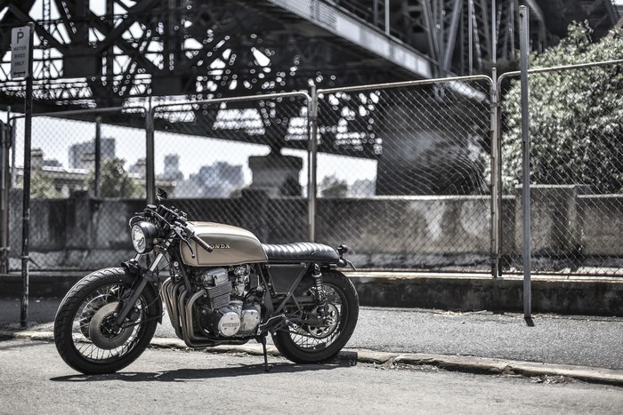 Gold Honda motorcycle parked near a bridge in Sydney