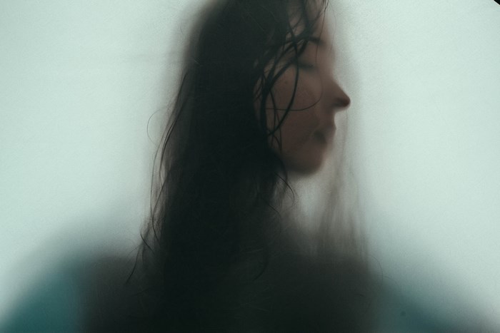 Woman behind a hazy window
