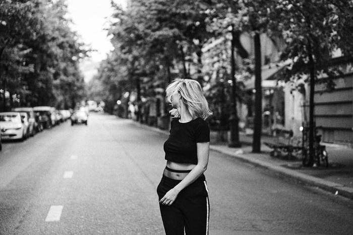 Woman with blonde hair spinning on a street