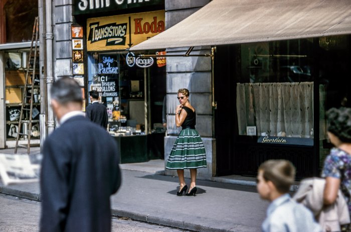 Woman in vintage dress outside Kodak store