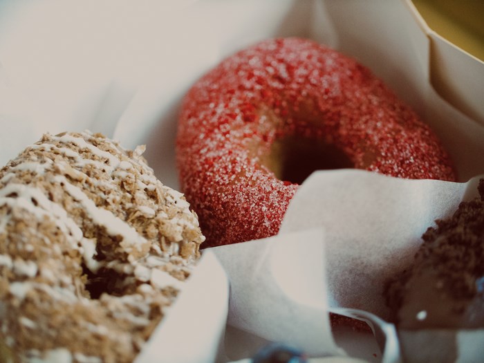 Close-up of three donuts in a box