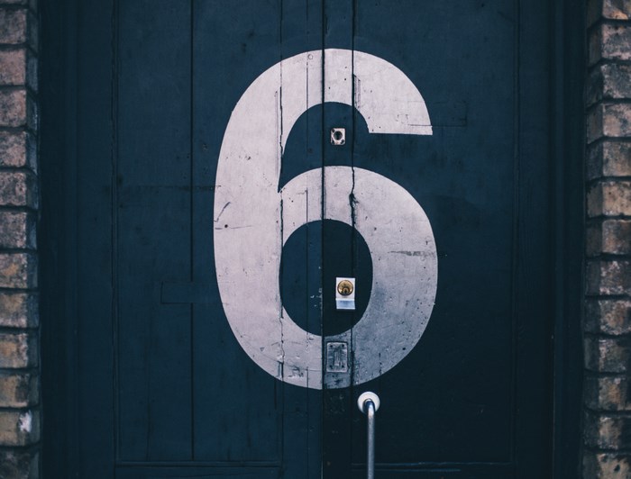 Number 6 on a dark wooden door