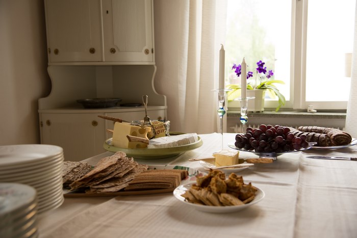 Table with cheese, grapes, bread, and crackers