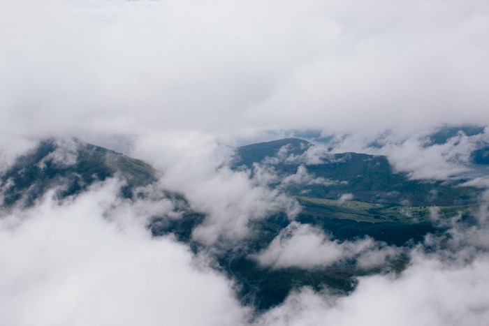 Aerial view of mountains shrouded in clouds