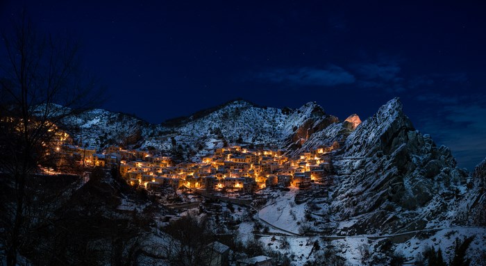 Illuminated Castelmezzano Mountain Village at Night with Snow
