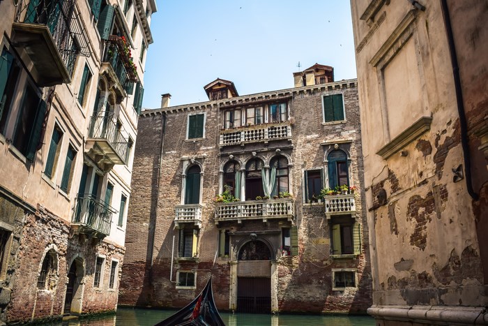 Venice canal with historic buildings and gondola