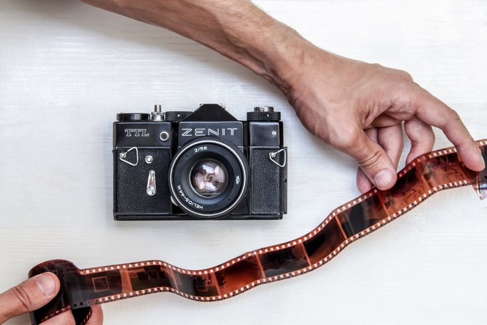 Zenit analog camera with film and hands