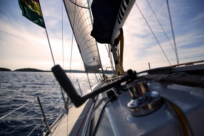 Sailing boat with sails up on the ocean