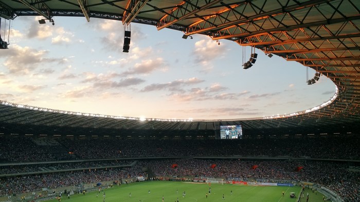 Soccer game in a stadium at sunset