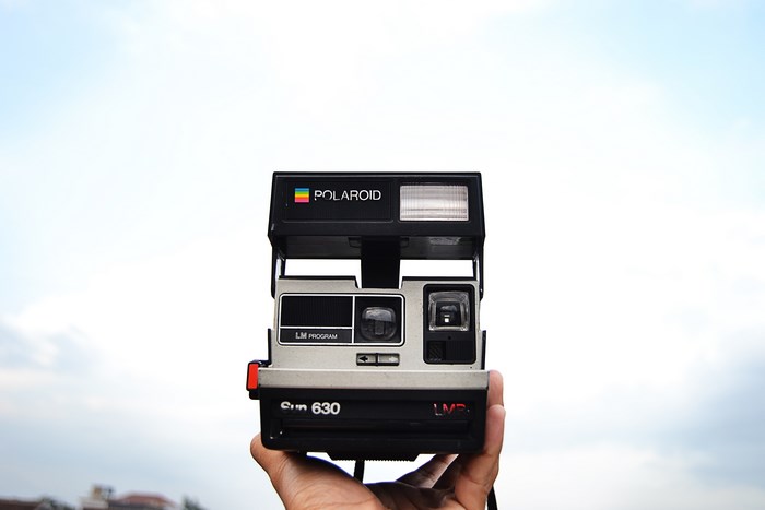 Polaroid Sun 630 LM Program camera held in hand