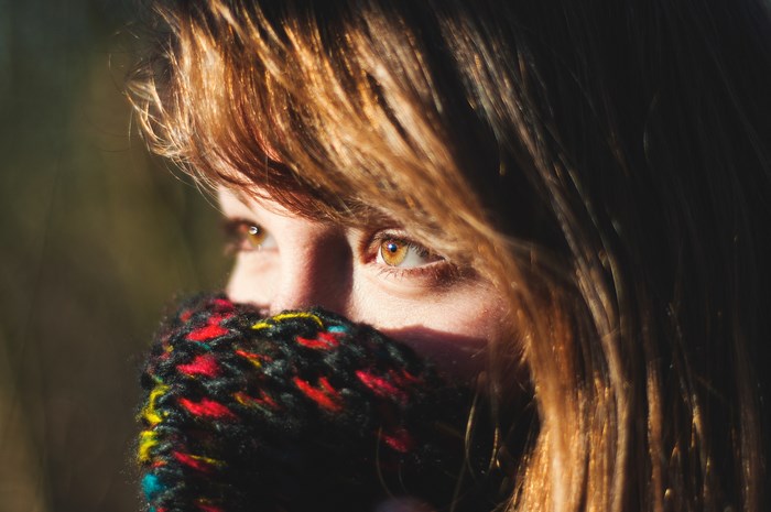 Woman with amber eyes wearing a colorful scarf