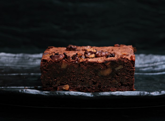 Chocolate walnut brownie on a dark plate