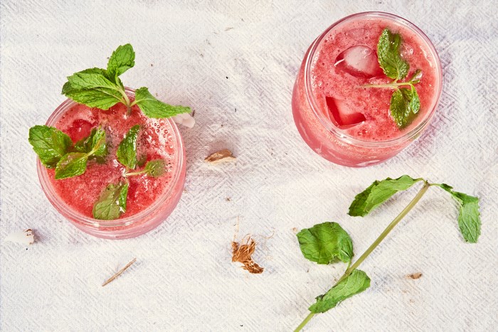 Two strawberry mojitos with mint and ice
