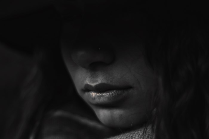 Close-up of a woman's face with dark lighting