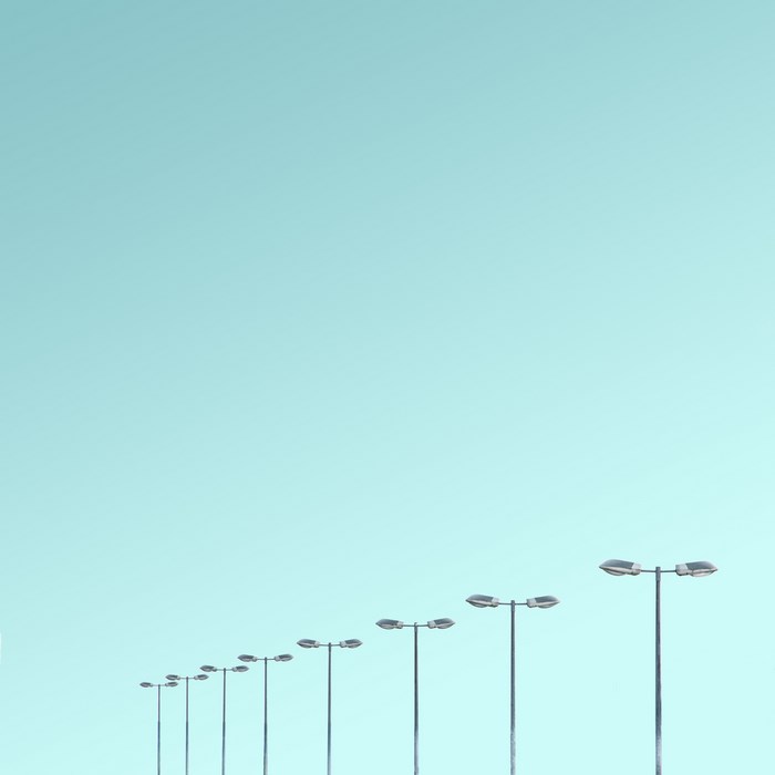 Street lights in a row against a clear sky