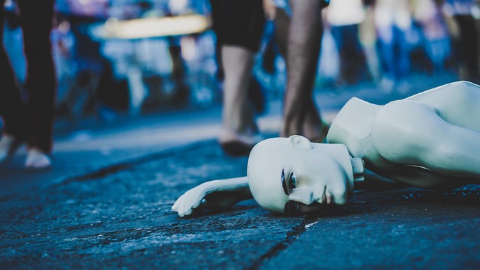Broken mannequin head lying on the ground