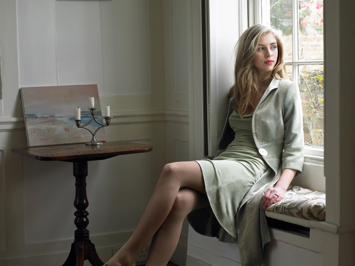 Hermione Corfield Sitting by a Window in Elegant Dress