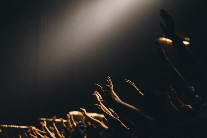 Audience with hands raised in a concert