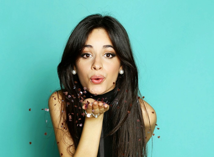 Camila Cabello blowing confetti