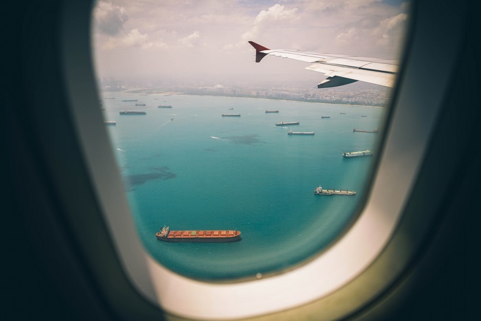 Airplane view of cargo ships in the ocean