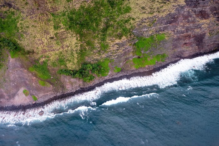 Aerial view of a rocky coast with waves crashing