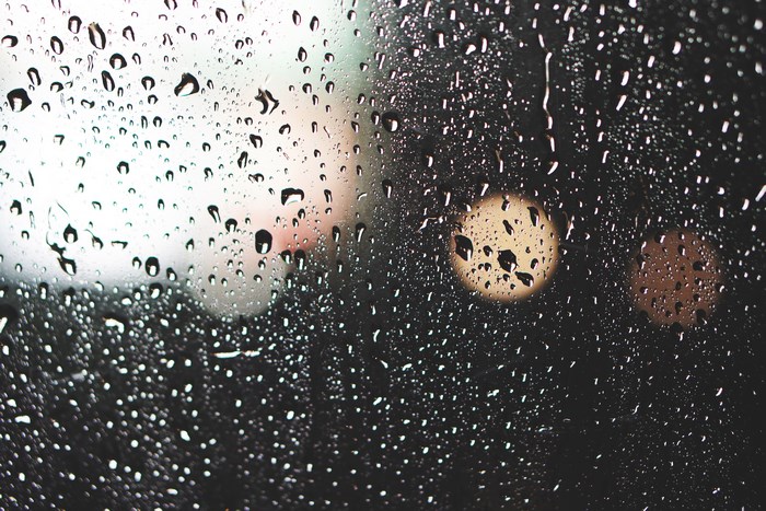 Raindrops on glass with bokeh lights