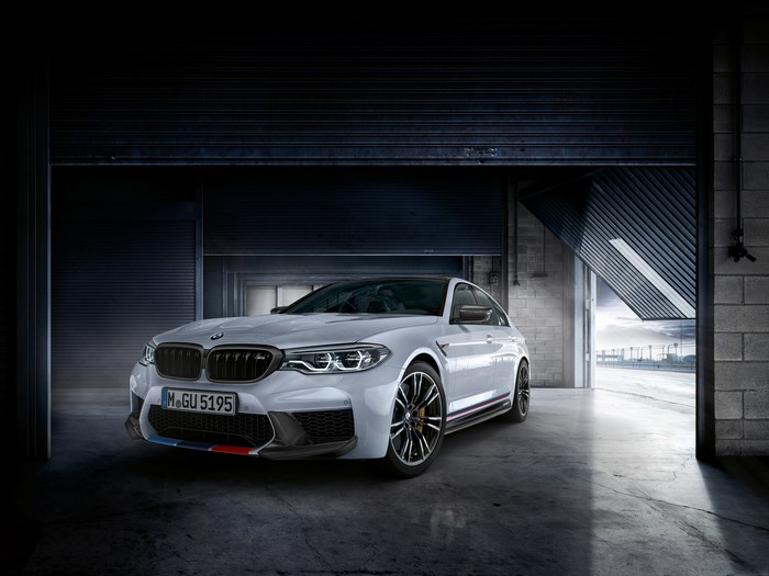 White BMW M5 in a garage