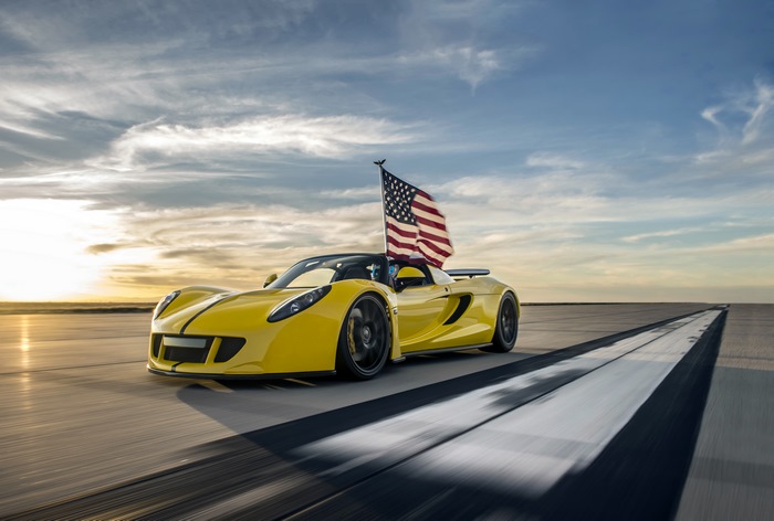 Yellow Hennessey Venom GT with USA flag on runway