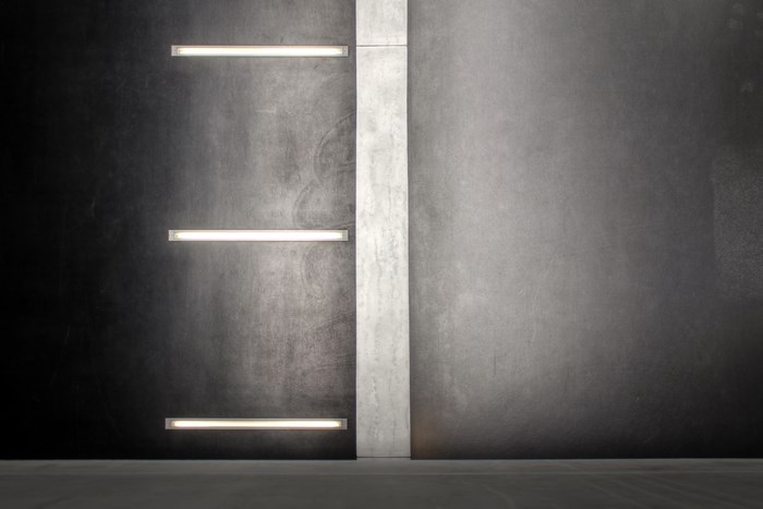 Modern interior with concrete divider and linear lights