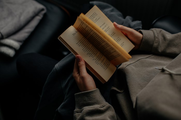 Person reading a paperback book