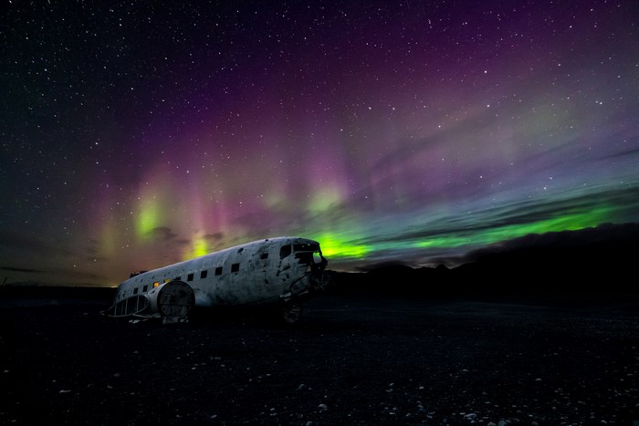 Abandoned airplane under the aurora borealis in Iceland