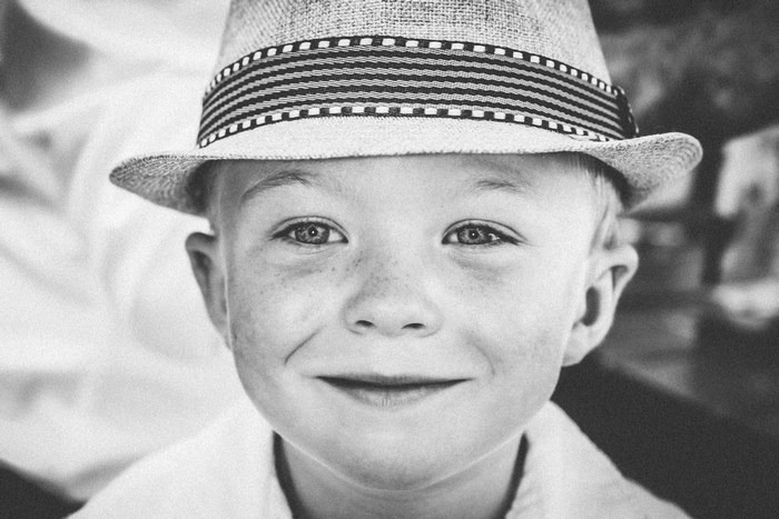 Boy wearing a fedora hat and smiling