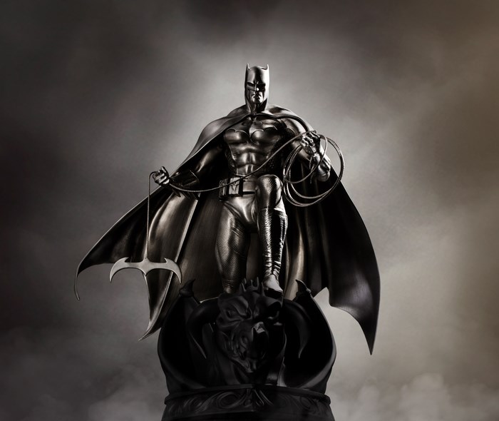 Batman statue with Batarang and grappling hook
