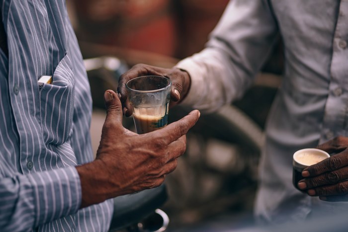 Two men sharing a cup of tea
