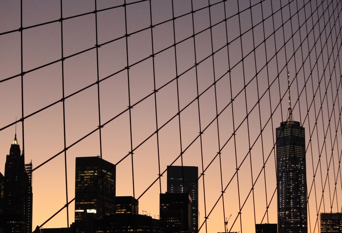 New York City skyline at sunset through a fence