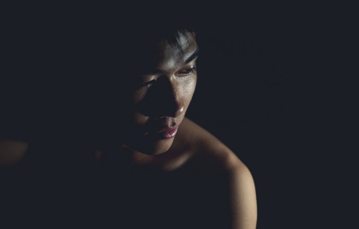 Man in shadow with light on face