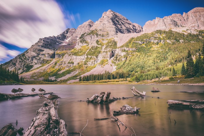 Maroon Bells lake with driftwood and mountains