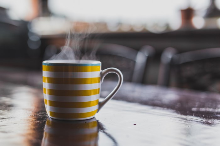 Yellow and white striped mug with steam