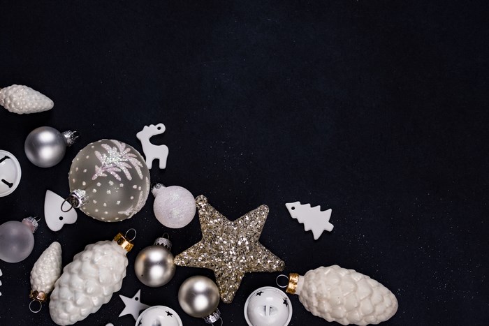 White Christmas ornaments on a black background