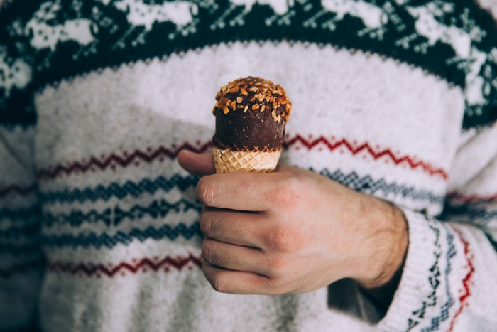 Man in Christmas Sweater Holding Chocolate Ice Cream Cone